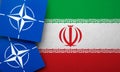 LONDON, UK - August 2022: NATO North Atlantic Treaty Organization military alliance logo on a Iran flag