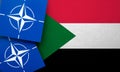 LONDON, UK - August 2022: NATO North Atlantic Treaty Organization military alliance logo on a Sudan flag