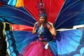 Notting Hill Carnival Woman wearing colorful butterfly wing costume