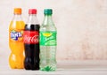 LONDON, UK - AUGUST 03, 2018: Plastic bottles of Coca Cola and Fanta and Sprite soft drink on wooden background. Most popular drin