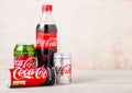LONDON, UK - AUGUST 03, 2018: Plastic and glass bottles with aluminium tins of Original Coca Cola , Diet Coke and Zero on woodden Royalty Free Stock Photo