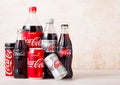 LONDON, UK - AUGUST 03, 2018: Plastic and glass bottles with aluminium tins of Original Coca Cola , Diet Coke and Zero on woodden Royalty Free Stock Photo