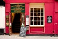 London, UK - August 17, 2010: typical british pub with red facade Royalty Free Stock Photo