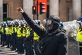 Black Lives Matter protest during lockdown coronavirus pandemic. Young protester in mask holding fist in the air in front of