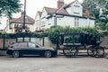 BMW Touring and a hearse parked on a side of a street in London