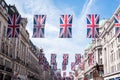 Close up of buildings on Regent Street London with row of British flags to celebrate the wedding of Prince Harry to Meghan Markle