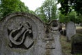 Close up photo of tombstone at the historic Jewish cemetery at Brady Street, Whitechapel, East London. Photo shows lyre or harp