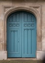 Details of Closed blue wooden church doorway in a gothic stone wall Royalty Free Stock Photo