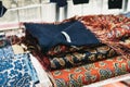 Stack of paisley scarves on the window display of Peckham Rye shop in Covent Garden, London, UK