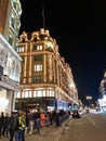 LONDON, UK - 29 DECEMBER 2019: The outside of Harrods Department Store in London at night during the Christmas Season.