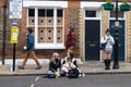 People eat street food while sitting on the curb. Brick Lane area Royalty Free Stock Photo