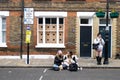 People eat street food while sitting on the curb. Brick Lane area Royalty Free Stock Photo