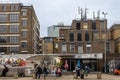 People eat street food while sitting on the curb. Brick Lane area Royalty Free Stock Photo