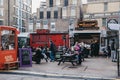 People enjoying street food in Elys Yard street food market in East London, UK