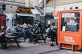 People enjoying street food in Elys Yard street food market in East London, UK