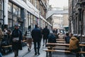 People walking on Dray Walk towards Elys Yard off Brick Lane, East London, UK Royalty Free Stock Photo