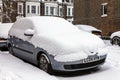 Street winter cityscape with snow covered frozen cars after a blizzard snowfall Royalty Free Stock Photo