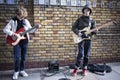 Teenagers play guitars during traditional Sunday lane flea market on Brick Lane Royalty Free Stock Photo