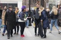 Young people talking to each other on the street. Girl with blue hair