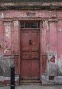 Doorway, part of the exterior of red painted traditional Huguenot weaver`s house on Princelet Street, Spitalfields, East London