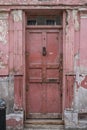 Doorway, part of the exterior of red painted traditional Huguenot weaver`s house on Princelet Street, Spitalfields, East London