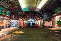 London, UK/Europe; 21/12/2019: Leake Street, underground tunnel with graffiti covered walls in London. Scene with pedestrians and Royalty Free Stock Photo