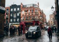London, UK/Europe; 20/12/2019: London, UK/Europe; 20/12/2019: Typical London scene of a taxi and a red telephone box in a street