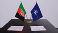 London, UK - 15 February 2023: Afghanistan country national flag and NATO flag. Politics and diplomacy illustration