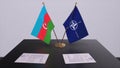 London, UK - 15 February 2023: Azerbaijan country national flag and NATO flag. Politics and diplomacy illustration