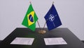 London, UK - 15 February 2023: Brazil country national flag and NATO flag. Politics and diplomacy illustration