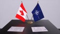 London, UK - 15 February 2023: Canada country national flag and NATO flag. Politics and diplomacy illustration