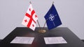 London, UK - 15 February 2023: Georgia country national flag and NATO flag. Politics and diplomacy illustration