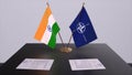 London, UK - 15 February 2023: India country national flag and NATO flag. Politics and diplomacy illustration