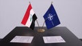 London, UK - 15 February 2023: Iraq country national flag and NATO flag. Politics and diplomacy illustration