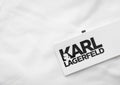 LONDON, UK - FEBRUARY 15, 2024: Karl Lagerfeld logo tag on premium white fabric t-shirt.Macro