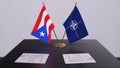 London, UK - 15 February 2023: Puerto Rico country national flag and NATO flag. Politics and diplomacy illustration