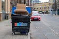 London UK February 2021 Recycling container filled with garbage in the Southwark area, cardboard boxes on top of the container
