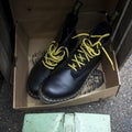 Spitalfields flea market. Well-worn boots with yellow laces in a cardboard box