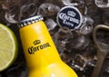 LONDON, UK - FEBRUARY 06, 2019: Steel Bottle of Corona Extra Beer Sunset Edition on wooden background with bottle opener and ice Royalty Free Stock Photo