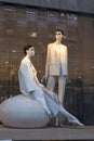 Two female mannequins in classic beige trouser suits are on display in a Zara storefront.