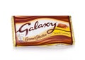 LONDON, UK - FEBRUARY 02, 2018: An unopened Galaxy chocolate bar with smooth caramel on white.Manufactured by Mars