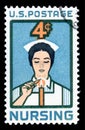 United States of America cancelled postage stamp showing an image of a Nurse lighting Candle of Dedication