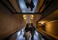 London, UK: Interior architecture of the Barbican Estate in the City of London with two people on a ramp
