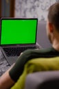 London, UK - January 12, 2022. Caucasian man uses MacBook Air M1. Person is working on latest Apple laptop with greenscreen of Royalty Free Stock Photo