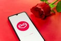 London, UK - 6 january 2021: close up of meetic dating app logo closeup on mobile phone with red rose. Concept of online dating .