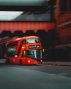 London UK January 2021 Panning shot of a popular red double decker London bus, background blurred in motion. Dark vertical moody Royalty Free Stock Photo