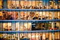 People working in an office building at night. Interior from the window