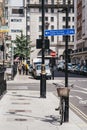 Bicycle by a lamppost and people walking in distance on a street in Marylebone, London, UK