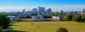 LONDON, UK - JULY 7, 2014: Canary Wharf view from the Greenwich hill. Modern skyscrapers of banking aria. Royalty Free Stock Photo