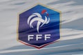 LONDON, UK - July 2023: France national football team logo badge on a flying flag. 3D Rendering